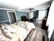 Spacious main bedroom offers ample natural light, wood-look floors, and decorative furnishings at 1718 Pucketts Sw Dr, Lilburn, GA 30047