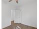 Clean bedroom featuring wood-look floors, a ceiling fan, closet, and a white door to the rest of the home at 3406 Randell Brown Avenue Unit 3, Atlanta, GA 30354