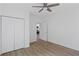 Comfortable bedroom featuring laminate flooring, a ceiling fan, and a closet providing ample storage space at 3406 Randell Brown Avenue Unit 3, Atlanta, GA 30354