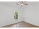 Bright bedroom with wood-look flooring, ceiling fan, and a sunlit window showcasing the outdoor greenery at 3406 Randell Brown Avenue Unit 3, Atlanta, GA 30354