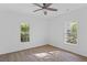 Bright bedroom with two windows and a ceiling fan showcasing laminate flooring and neutral walls for a peaceful retreat at 3406 Randell Brown Avenue Unit 3, Atlanta, GA 30354