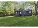 Inviting single-story house with a green lawn, complemented by the natural beauty of the surrounding trees and landscape at 3406 Randell Brown Avenue Unit 3, Atlanta, GA 30354