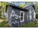 Side view of a two-story home showcasing the dark siding, windows, mature trees, and well-maintained lawn at 3406 Randell Brown Avenue Unit 3, Atlanta, GA 30354
