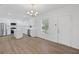 Bright kitchen featuring white cabinets, stainless steel appliances, a center island, and wood-look flooring at 3406 Randell Brown Avenue Unit 3, Atlanta, GA 30354