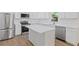 Modern kitchen showcasing white cabinetry, stainless steel appliances, and a functional center island for meal preparation at 3406 Randell Brown Avenue Unit 3, Atlanta, GA 30354