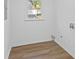 Laundry room with wood-look flooring, bright light from the window, and washer/dryer hookups at 3406 Randell Brown Avenue Unit 3, Atlanta, GA 30354