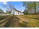 Beautiful backyard with patchy grass and wooded area at 5882 Riverside Walk Dr, Sugar Hill, GA 30518