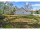 Large backyard with patchy grass and a white fence at 5882 Riverside Walk Dr, Sugar Hill, GA 30518