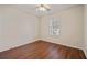 Bedroom showcasing wood floors, ceiling fan, and a window at 5882 Riverside Walk Dr, Sugar Hill, GA 30518
