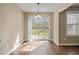 Bright breakfast nook with stylish chandelier lighting and view of the backyard through the glass sliding door at 5882 Riverside Walk Dr, Sugar Hill, GA 30518