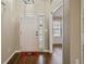 Entry way showing hardwood floors and view into a naturally lit room at 5882 Riverside Walk Dr, Sugar Hill, GA 30518