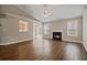 Spacious living room featuring hardwood floors, neutral walls, a ceiling fan, and a fireplace at 5882 Riverside Walk Dr, Sugar Hill, GA 30518