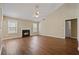 Spacious living room featuring hardwood floors, neutral walls, a ceiling fan, and a fireplace at 5882 Riverside Walk Dr, Sugar Hill, GA 30518