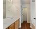 Double sink vanity with view into the hallway at 5882 Riverside Walk Dr, Sugar Hill, GA 30518