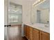 Double sink vanity with view into the main bedroom at 5882 Riverside Walk Dr, Sugar Hill, GA 30518