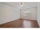 Spacious main bedroom featuring tray ceiling, ceiling fan, and large window at 5882 Riverside Walk Dr, Sugar Hill, GA 30518