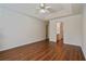 Large main bedroom featuring tray ceilings, ceiling fan and view to the bathroom at 5882 Riverside Walk Dr, Sugar Hill, GA 30518