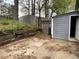 Backyard with a small shed and a wooden retaining wall at 6113 Princeton Ave, Morrow, GA 30260
