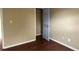 Bedroom featuring wood flooring, neutral walls, and a closet with a partially open door at 6113 Princeton Ave, Morrow, GA 30260