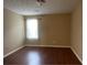 Bright bedroom with hardwood floors and a large window at 6113 Princeton Ave, Morrow, GA 30260