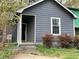 Charming home featuring gray siding, a covered porch, and well-kept landscaping at 6113 Princeton Ave, Morrow, GA 30260