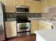 Kitchen with stainless steel appliances and yellow-painted cabinets at 6113 Princeton Ave, Morrow, GA 30260