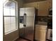 Stainless steel refrigerator in the kitchen next to a window offering natural light at 6113 Princeton Ave, Morrow, GA 30260