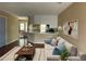 Living room features modern furniture and view to the kitchen and dining area at 6113 Princeton Ave, Morrow, GA 30260