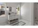 Bright bathroom with a classic white vanity, marble floors, and vintage-inspired fixtures at 1311 Berwick Ne Ave, Atlanta, GA 30306