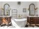 Elegant bathroom featuring dual vanities, a soaking tub, and chic geometric tile flooring at 1311 Berwick Ne Ave, Atlanta, GA 30306