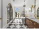 Bathroom boasts a luxurious soaking tub, dual vanities, and stylish black and white tile at 1311 Berwick Ne Ave, Atlanta, GA 30306