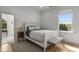 Bright bedroom featuring a queen-sized bed, wood floors, large windows, and a gray rug at 1311 Berwick Ne Ave, Atlanta, GA 30306