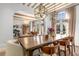Dining and living area boasts exposed beams, an oversized dining table, and stylish comfortable seating at 1311 Berwick Ne Ave, Atlanta, GA 30306