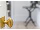 Close-up of a brass door knob with a hammered texture, offering a glimpse into the bright interior at 1311 Berwick Ne Ave, Atlanta, GA 30306