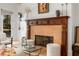 Living room fireplace with carved wood mantle and adjacent sitting area at 1311 Berwick Ne Ave, Atlanta, GA 30306