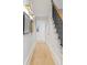 Hallway features wood floors, staircase with metal railing, and designer lighting at 1311 Berwick Ne Ave, Atlanta, GA 30306