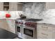 Gourmet kitchen features a Wolf range, marble backsplash, and custom cabinets at 1311 Berwick Ne Ave, Atlanta, GA 30306
