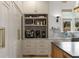Custom kitchen cabinets with hidden pantry area and marble backsplash at 1311 Berwick Ne Ave, Atlanta, GA 30306