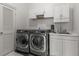 Laundry room area equipped with a washer, dryer, sink and storage cabinets at 1311 Berwick Ne Ave, Atlanta, GA 30306