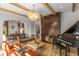 Inviting living room featuring hardwood floors, a decorative fireplace, exposed beams, and an adjacent dining area at 1311 Berwick Ne Ave, Atlanta, GA 30306