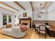 Open-concept living space with modern furniture, a cozy banquette, and a statement fireplace at 1311 Berwick Ne Ave, Atlanta, GA 30306