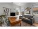 Functional home office with a wooden desk, gray sofa, and natural light, providing a comfortable workspace at 1311 Berwick Ne Ave, Atlanta, GA 30306