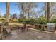 Outdoor stone patio features a gas grill, built-in outdoor kitchen, and dining set at 1311 Berwick Ne Ave, Atlanta, GA 30306