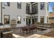 Back patio with outdoor kitchen, stone accents, a dining set, and a sitting bench at 1311 Berwick Ne Ave, Atlanta, GA 30306