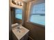Bathroom with a single sink vanity, mirror, and window for natural light at 1968 Copperfield Cir, Decatur, GA 30035