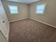 Cozy bedroom with neutral carpet, two windows providing natural light, and a calming atmosphere at 1968 Copperfield Cir, Decatur, GA 30035