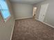Bright bedroom featuring neutral carpet, a large window, and access door at 1968 Copperfield Cir, Decatur, GA 30035