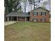 Charming two-story brick home with a covered carport and a well-manicured lawn at 1968 Copperfield Cir, Decatur, GA 30035