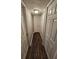 Neutral hallway featuring hardwood floors and multiple closet doors for ample storage at 1968 Copperfield Cir, Decatur, GA 30035