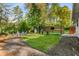 Spacious backyard with manicured green lawn, seating area, and wooden privacy fence at 2322 Poplar Springs Ne Dr, Brookhaven, GA 30319